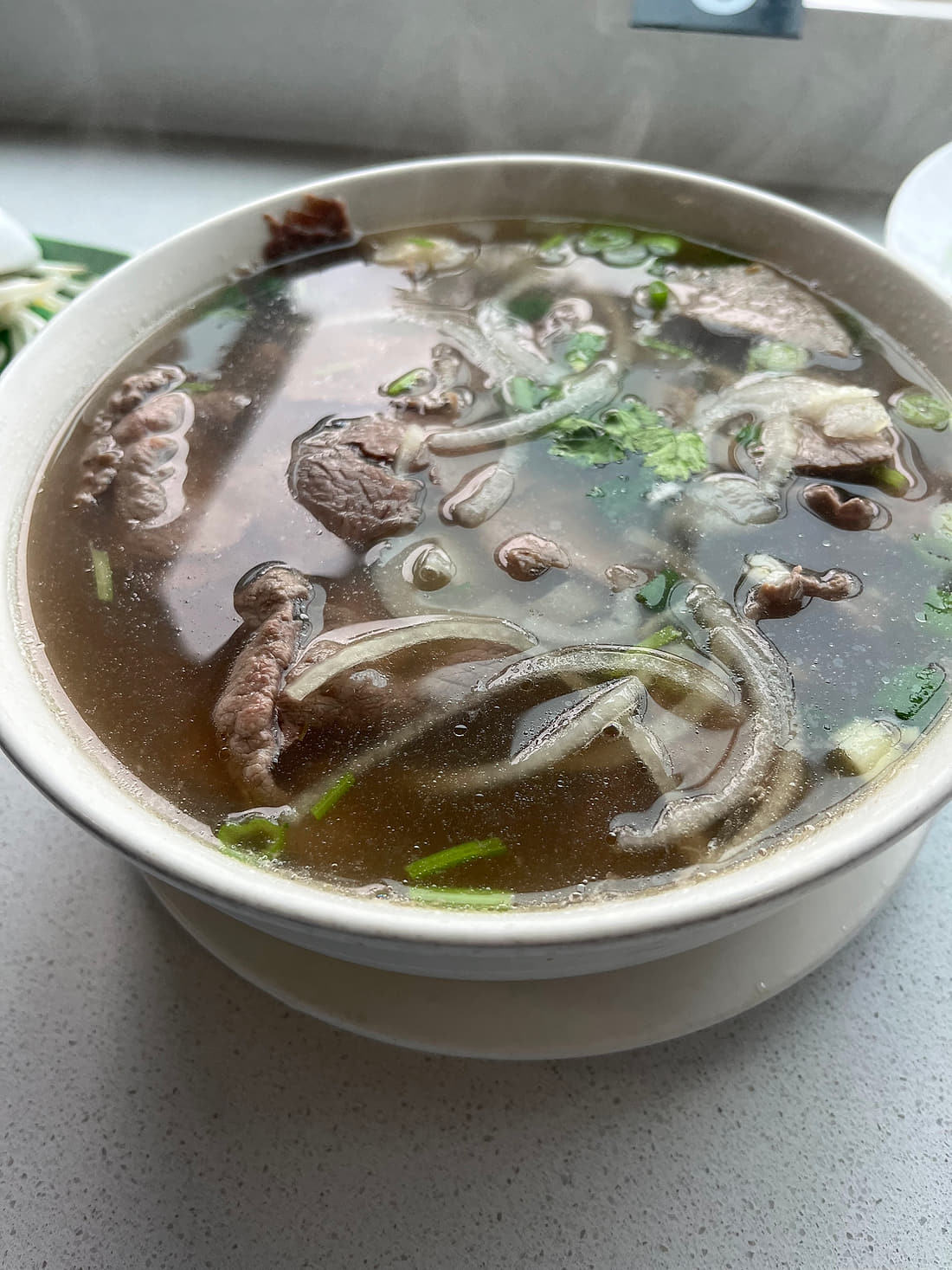 Beef pho at Basil Viet Kitchen, Seattle — rice noodles and sliced beef in broth