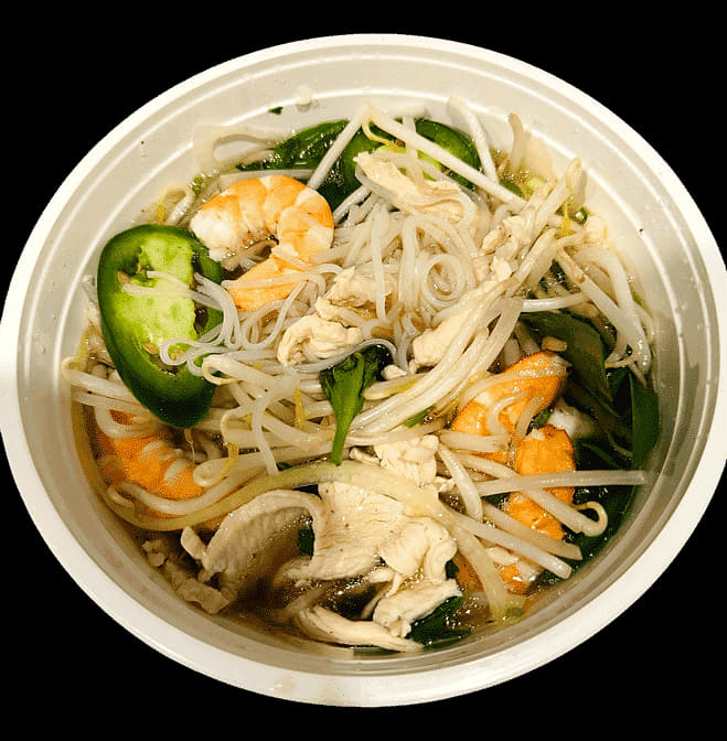 Chicken and shrimp pho with bean sprouts and sliced jalapeño