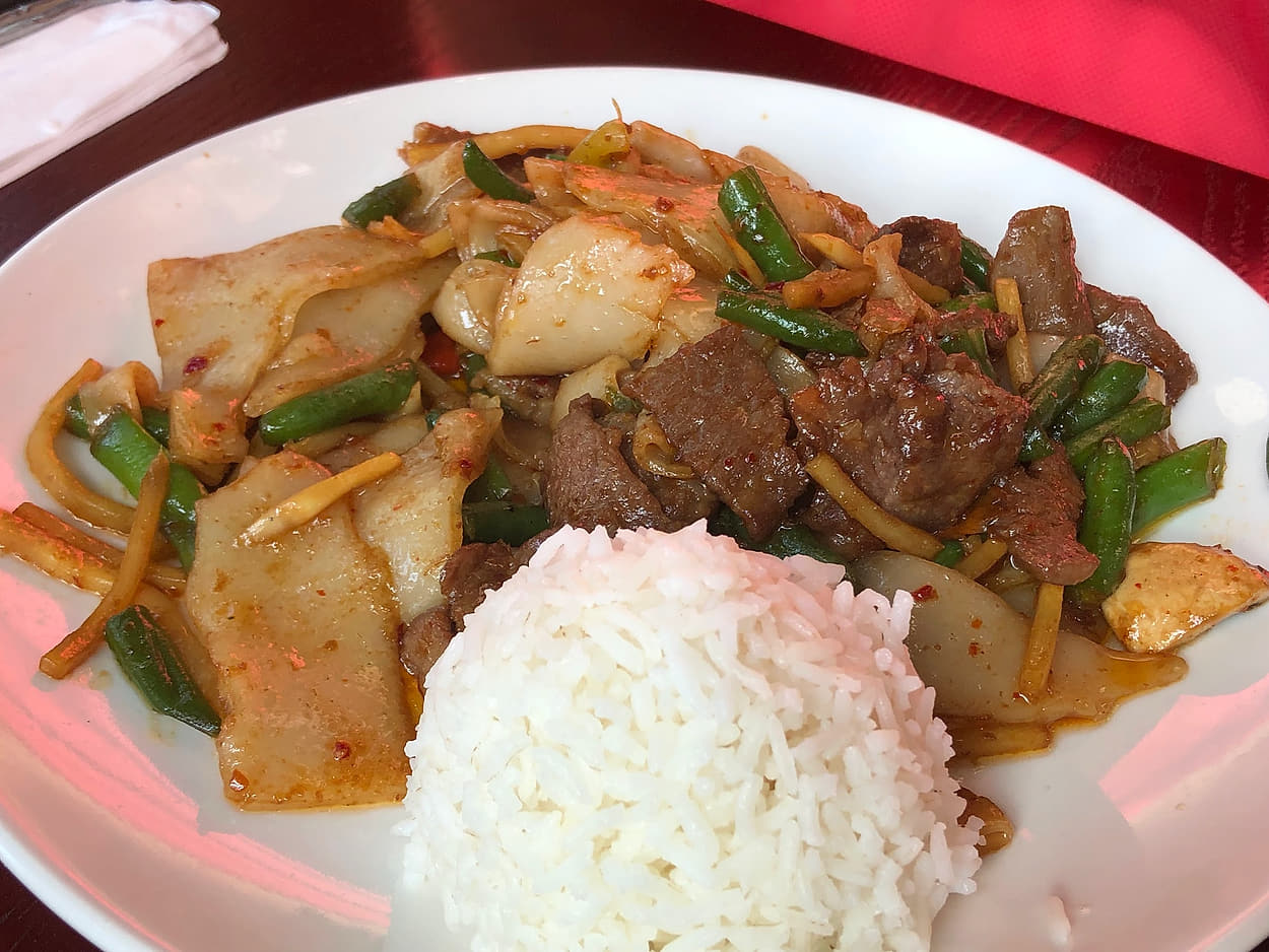 Wok-fried wide rice noodles with beef and green beans, served with steamed rice